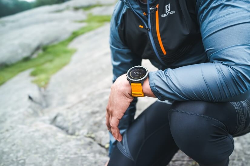 Спортсмен присел, на руке Suunto Spartan Sport Wrist HR Baro Amber